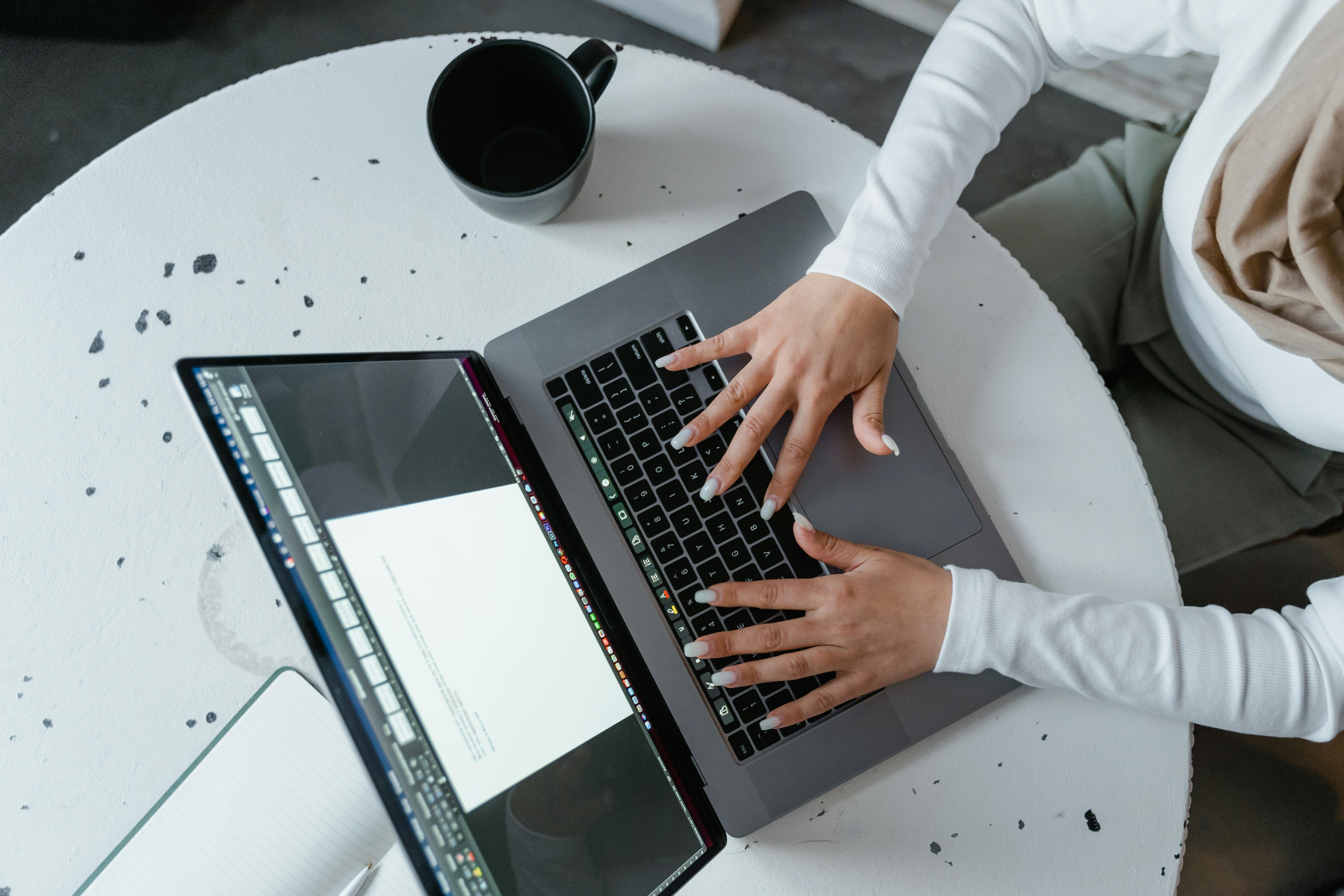 Employee safely working on a laptop that's protected by Sentry Technology Solutions