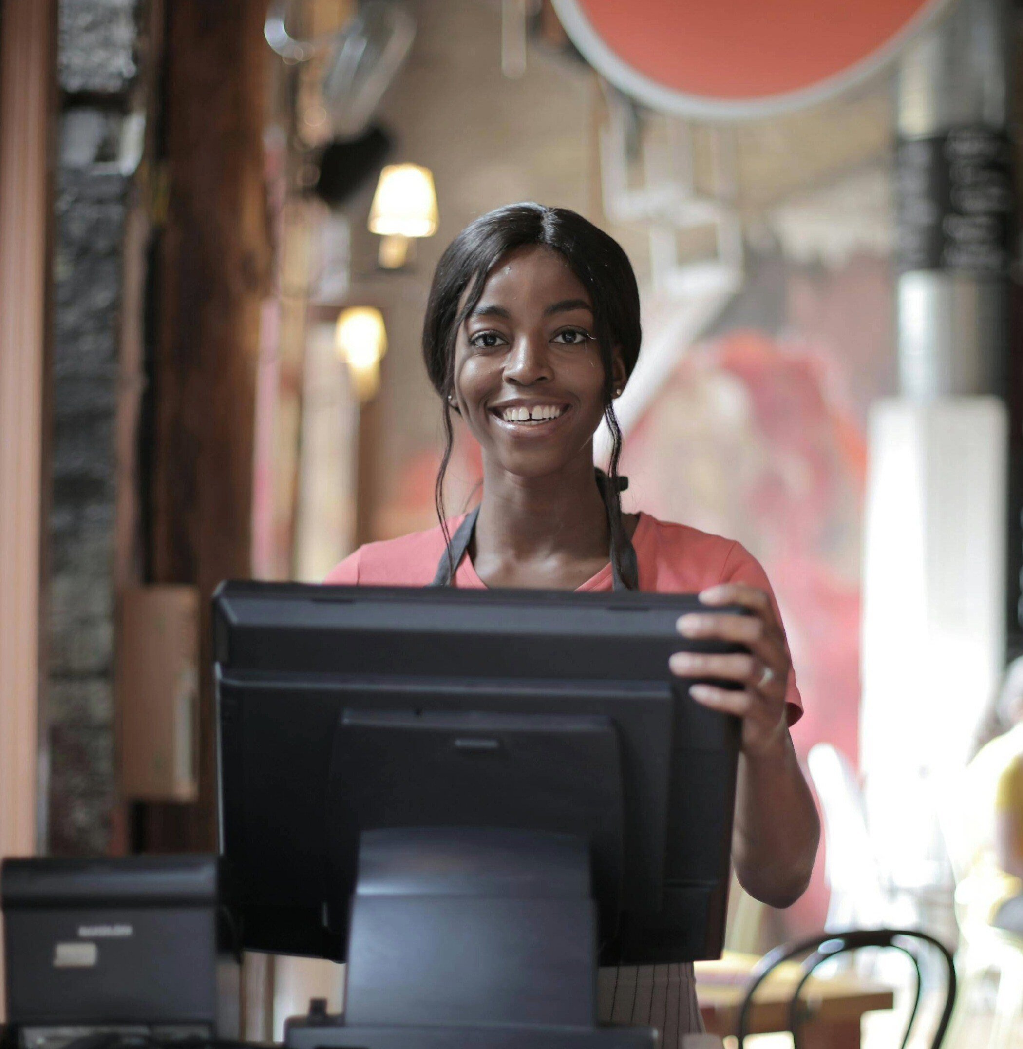 Woman working front desk and recieving personal support from Sentry Tech Solutions